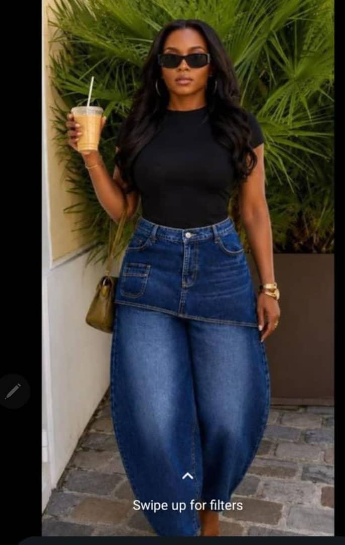Front view of skirt-overlay wide-leg jeans worn with a black top